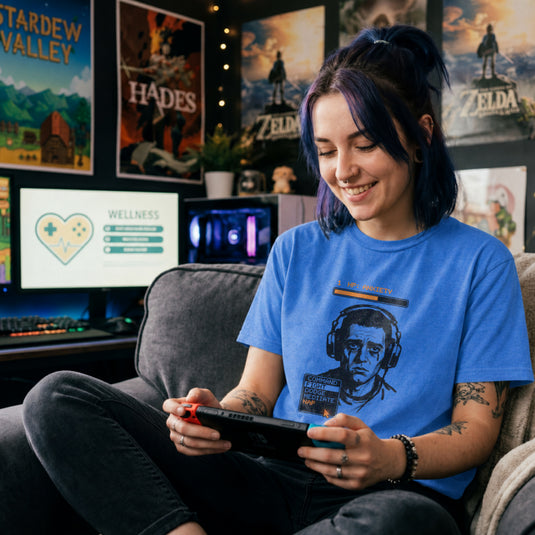 Translation missing: en.Heather royal t-shirt with a tired gamer graphic, an orange 1 HP Anxiety bar, and an RPG menu selecting the NAP option