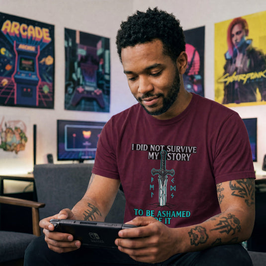 Translation missing: en.Maroon t-shirt with a fantasy sword in the ground, glowing runes, and a motivational story survivor quote