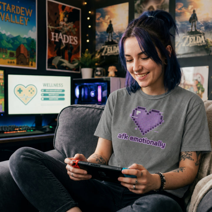Translation missing: en.Graphite heather t-shirt featuring a purple pixel art glitch heart with lowercase text reading afk emotionally