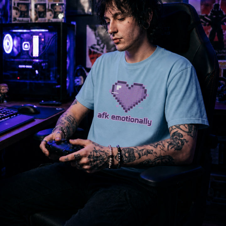 Translation missing: en.Light blue t-shirt featuring a purple pixel art glitch heart with lowercase text reading afk emotionally