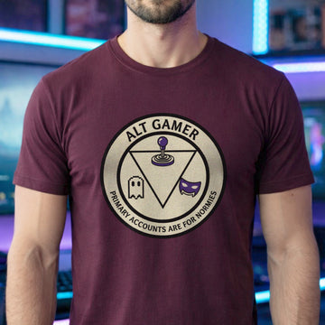 Translation missing: en.Maroon t-shirt with a retro arcade badge reading Alt Gamer Primary Accounts Are For Normies with purple joystick