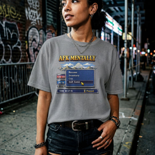 Translation missing: en.Graphite heather tee with gold AFK Mentally text over a pixel art retro RPG menu box with a cursor hovering on Quit Game