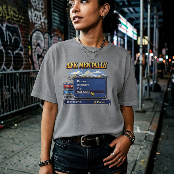 Translation missing: en.Graphite heather tee with gold AFK Mentally text over a pixel art retro RPG menu box with a cursor hovering on Quit Game