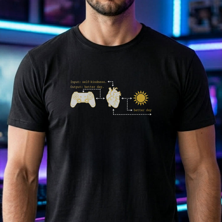 Translation missing: en.Black tee with gold flowchart connecting a game controller, anatomical heart, sun, and text Input self-kindness