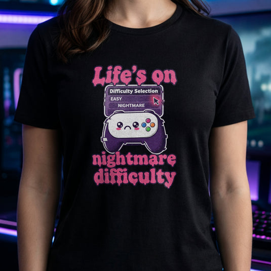 Translation missing: en.Black tee with pink text reading Life's on nightmare difficulty next to a sad controller and difficulty selector