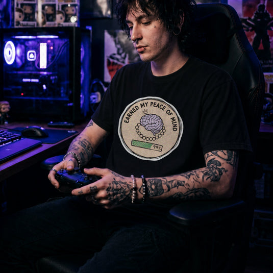 Translation missing: en.Black cotton tee with brain illustration coin graphic and text "EARNED MY PEACE OF MIND"