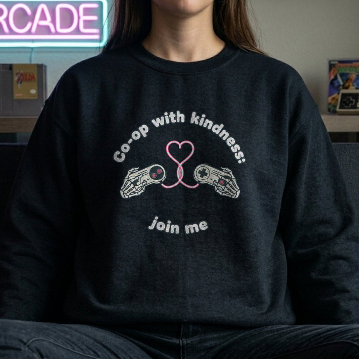 Translation missing: en.Black unisex crewneck sweatshirt with gamepad heart graphic reading, co-op with kindness join me