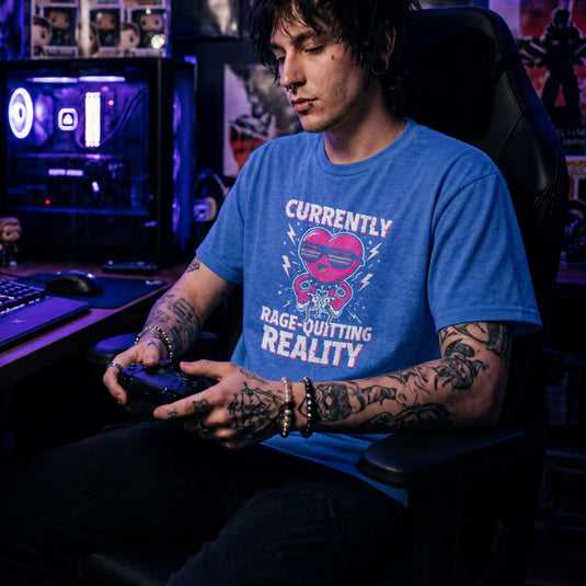 Translation missing: en.Heather royal tee with a pink heart cartoon wearing sunglasses, ripping a controller, and Rage-Quitting Reality text