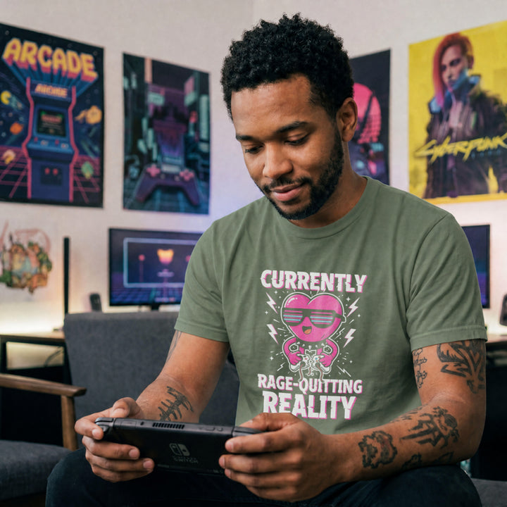Translation missing: en.Military green tee with a pink heart cartoon wearing sunglasses, ripping a controller, and Rage-Quitting Reality text