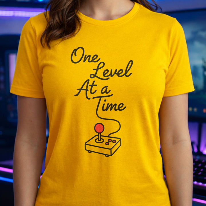 Translation missing: en.Daisy Cotton tee with retro arcade joystick graphic and text "One Level At A Time"