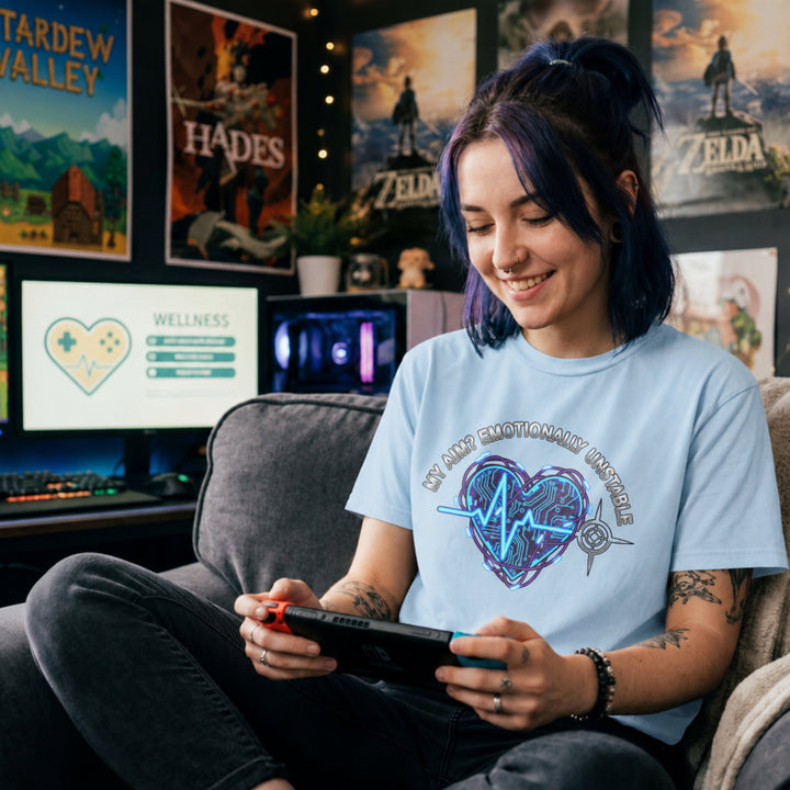 Translation missing: en.Light blue tee with text My Aim Emotionally Unstable around a glowing cyber circuit heart, pulse line, and crosshair