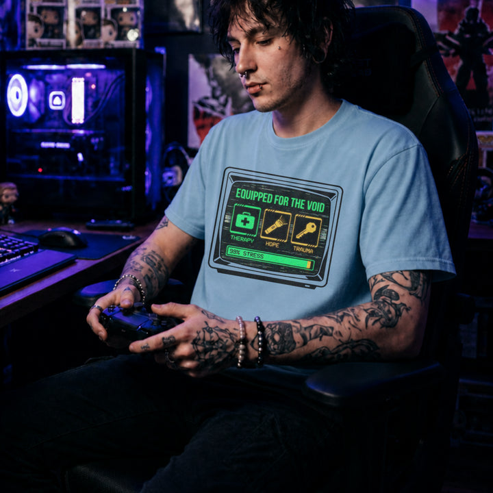 Translation missing: en.Light Blue t-shirt showing a retro monitor displaying inventory items Therapy, Hope, and Trauma with a 99% Stress bar