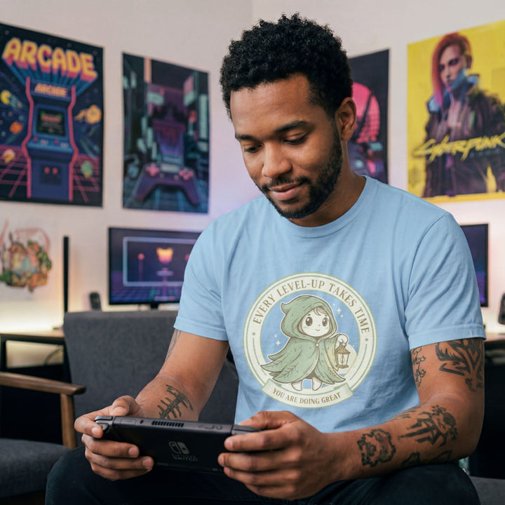Translation missing: en.Tee with Circular green emblem showing a cute hooded fantasy character holding a lantern with Every Level-Up Takes Time text