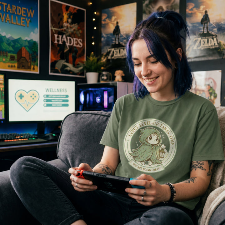 Translation missing: en.Tee with Circular green emblem showing a cute hooded fantasy character holding a lantern with Every Level-Up Takes Time text