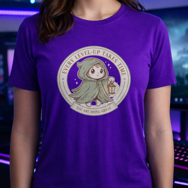 Translation missing: en.Tee with Circular green emblem showing a cute hooded fantasy character holding a lantern with Every Level-Up Takes Time text