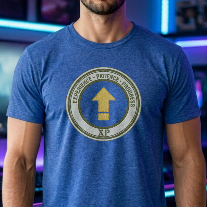 Translation missing: en.Heather royal t-shirt with a green circular emblem reading Experience Patience Progress XP around a gold level up arrow