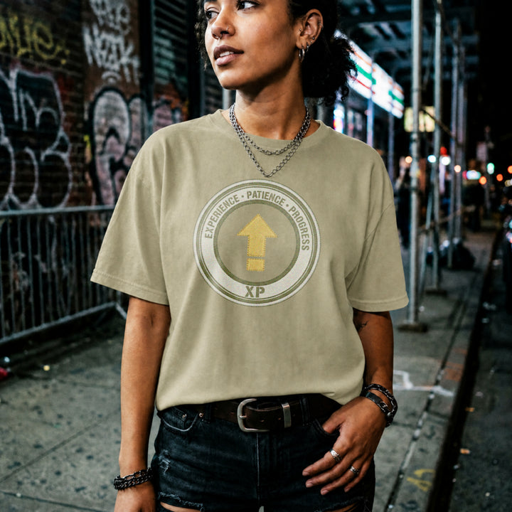 Translation missing: en.Natural t-shirt with a green circular emblem reading Experience Patience Progress XP around a gold level up arrow
