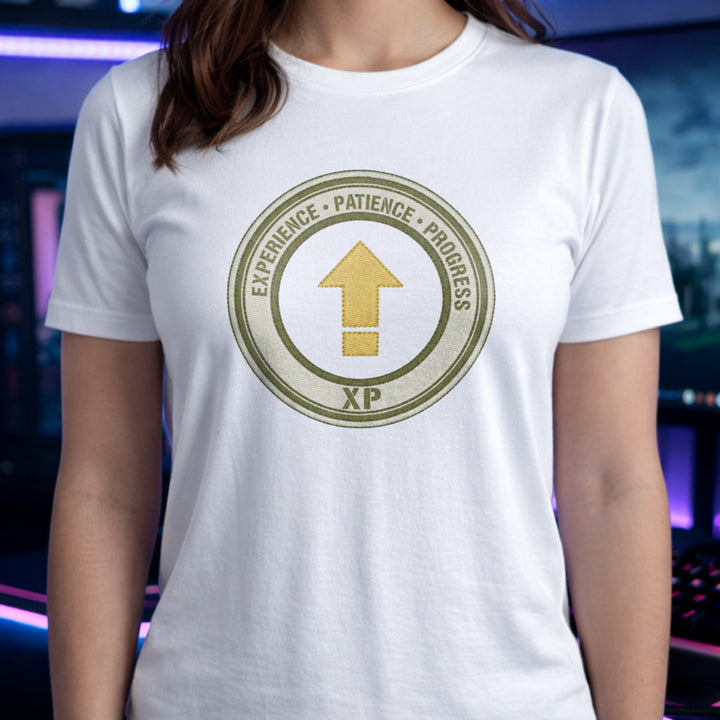 Translation missing: en.White t-shirt with a green circular emblem reading Experience Patience Progress XP around a gold level up arrow