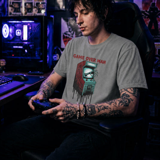 Translation missing: en.Sports grey shirt graphic showing a monster hand clawing out of a melting retro arcade screen reading GAME OVER MAN