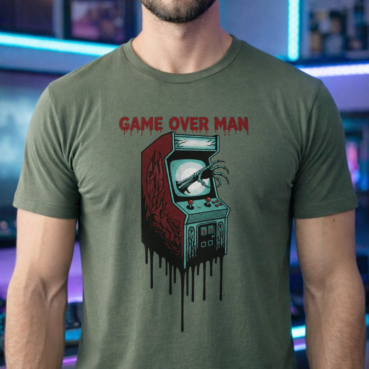 Translation missing: en.Military green shirt graphic showing a monster hand clawing out of a melting retro arcade screen reading GAME OVER MAN