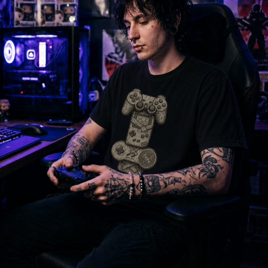 Translation missing: en.Black t-shirt with a sketch graphic of stacked, cracked stone game controllers taped together like a totem pole
