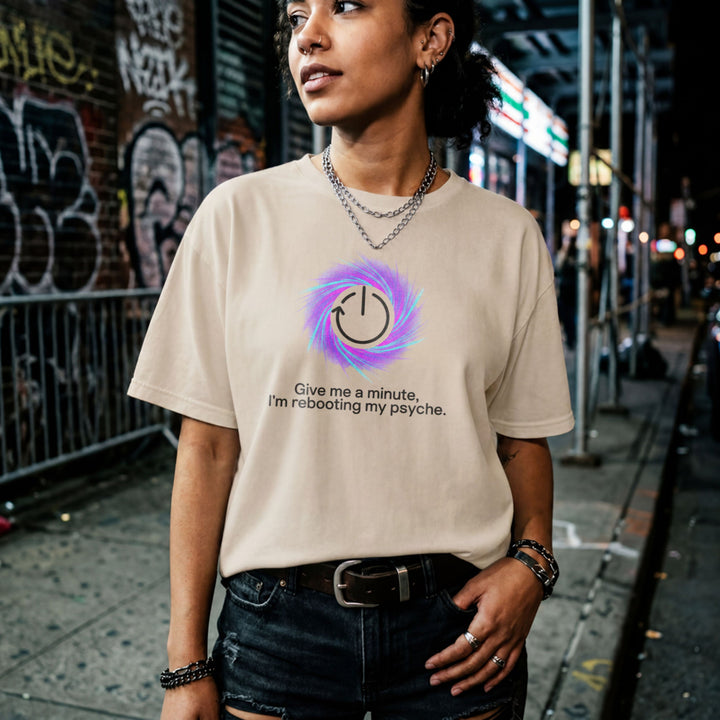 Translation missing: en.Sand t-shirt graphic with a restart symbol over a purple swirl reading Give me a minute, I'm rebooting my psyche