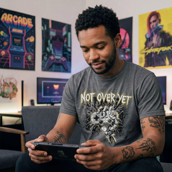 Translation missing: en.Graphite heather cotton tee with bone hand holding gamepad graphic text 'Not Over Yet'