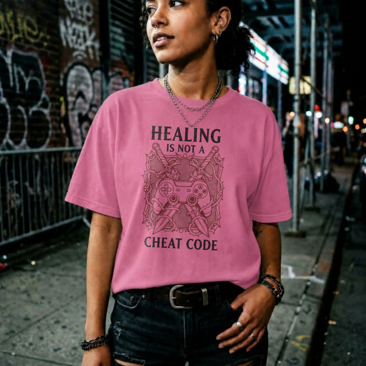 Translation missing: en.Azalea gamer tee graphic with crossed swords, controller, and thorns text Healing Is Not A Cheat Code. 