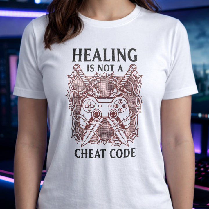 Translation missing: en.White gamer tee graphic with crossed swords, controller, and thorns text Healing Is Not A Cheat Code. 