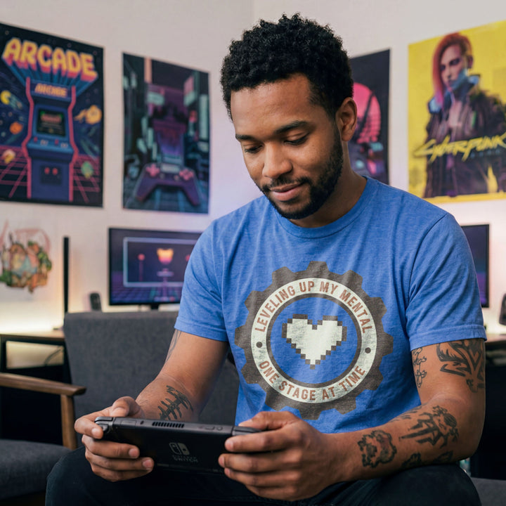 Translation missing: en.Heather royal tee with pixel heart centered in cog badge graphic text, "leveling up my mental one stage at a time"