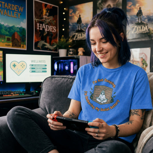Translation missing: en.Heather royal gamer tee graphic with text I'm Not Camping, I'm Recharging My Social Battery and person in a wooden box