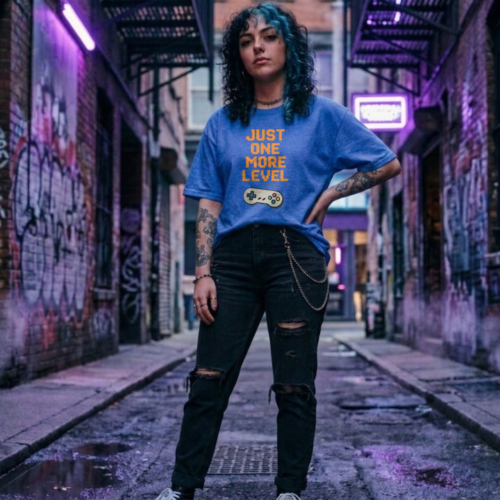 Translation missing: en.Retro heather royal t-shirt with orange pixelated text reading Just One More Level above a classic retro game controller