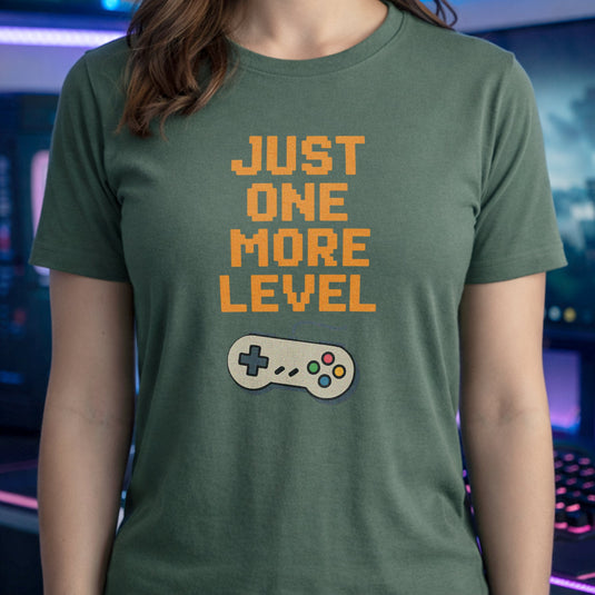 Translation missing: en.Retro military green t-shirt with orange pixelated text reading Just One More Level above a classic retro game controller