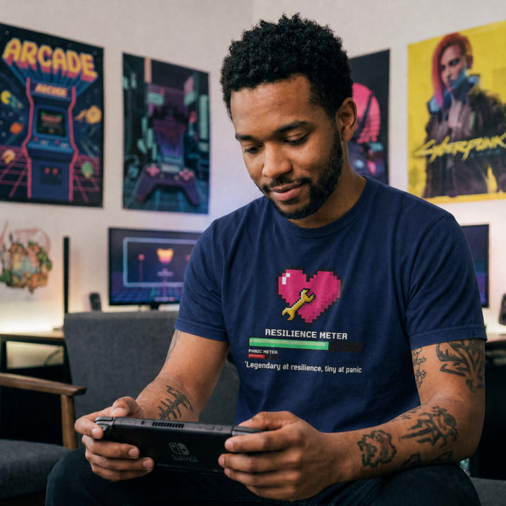 Translation missing: en.Navy gamer tee graphic with pixel heart, wrench, loading bar, and text Legendary at resilience, tiny at panic