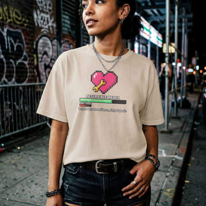 Translation missing: en.Sand gamer tee graphic with pixel heart, wrench, loading bar, and text Legendary at resilience, tiny at panic