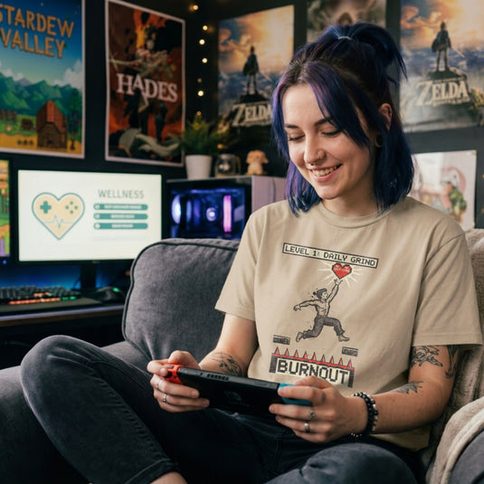 Translation missing: en.Sand tee with a platformer game graphic of a man jumping over spikes labeled Burnout to reach a self-care heart