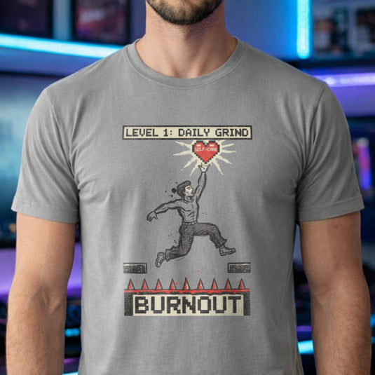 Translation missing: en.Alt n Vibe sports grey tee with a platformer game graphic of a man jumping over spikes labeled Burnout to reach a self-care heart