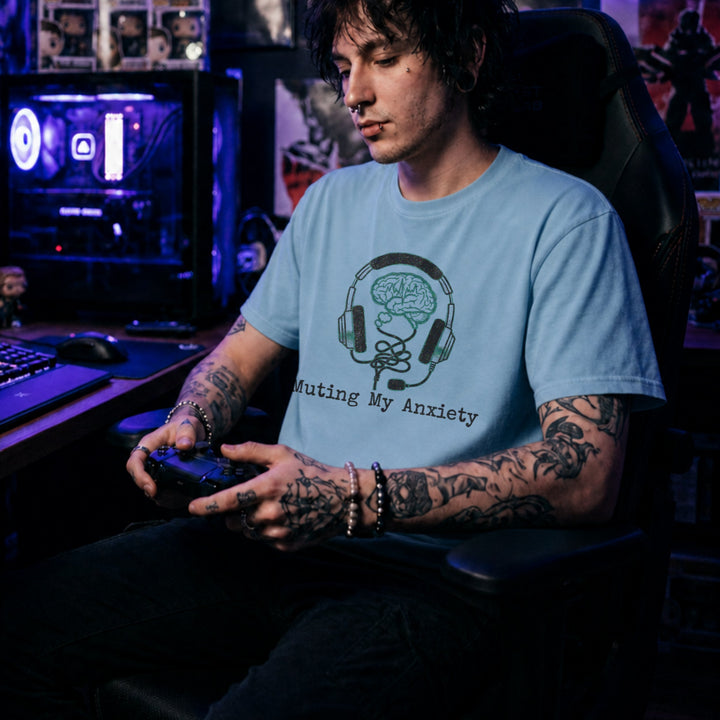 Translation missing: en.Light Blue tee with graphic: headphones connected to a brain and text, "Muting my anxiety"