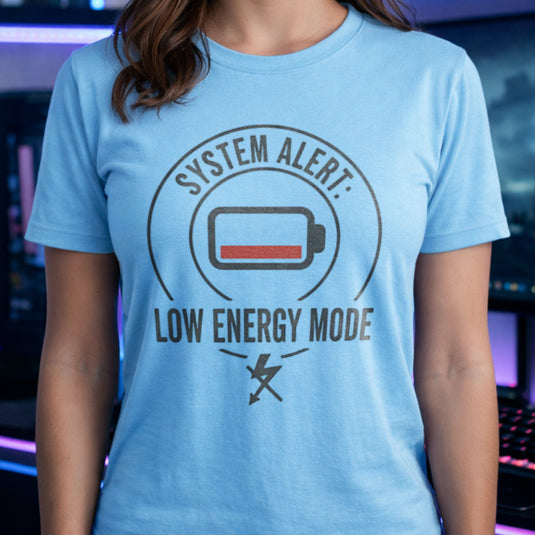 Translation missing: en.Light blue cotton t-shirt with a graphic low battery icon design and text 'SYSTEM ALERT: LOW ENERGY MODE' 