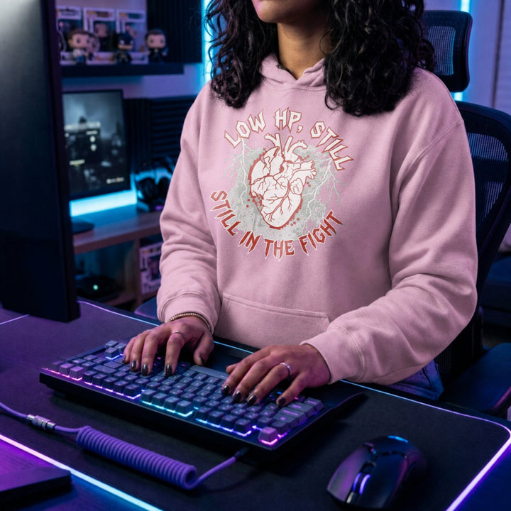 Translation missing: en.Light pink pullover hoodie with heart graphic text, LOW HP STILL IN THE FIGHT