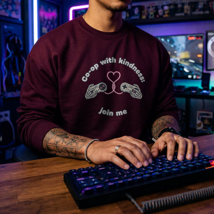 Translation missing: en.Maroon unisex crewneck sweatshirt with gamepad heart graphic reading, co-op with kindness join me