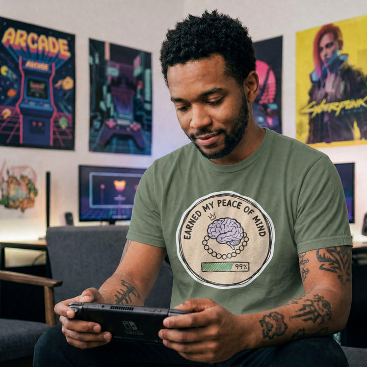 Translation missing: en.Military green cotton tee with brain illustration coin graphic and text "EARNED MY PEACE OF MIND"