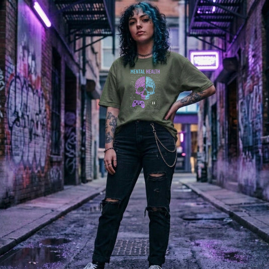 Translation missing: en.Military green shirt with text Mental Health above a split purple and blue skull brain graphic, controller, and circuits