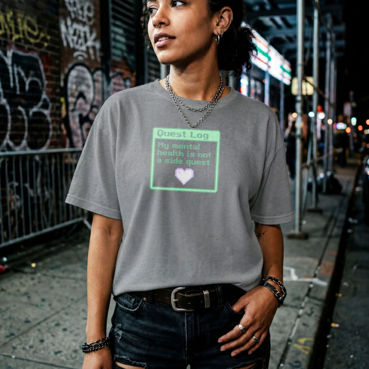 Translation missing: en.Graphite heather shirt with a green pixel art quest log graphic reading My mental health is not a side quest with a heart
