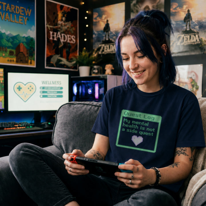Translation missing: en.Navy shirt with a green pixel art quest log graphic reading My mental health is not a side quest with a heart