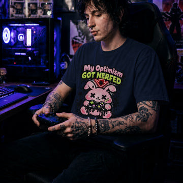Translation missing: en.Navy t-shirt with a pink cartoon character and text, My Optimism Got Nerfed in a gaming-themed design