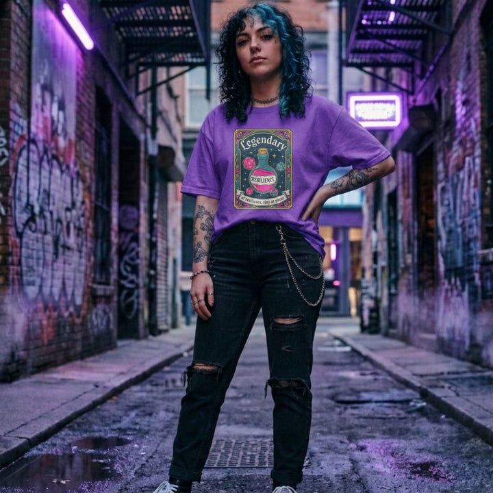 Translation missing: en.purple cotton tee with dice and resilience potion tarot card graphic and text, "Legendary at resilience, tiny at panic"