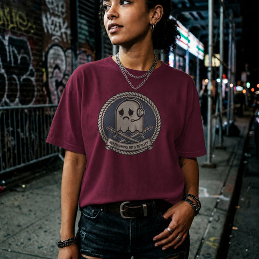 Translation missing: en.Maroon t-shirt badge with a sad arcade ghost wearing a headset, crossed swords and Respawning Into Reality text