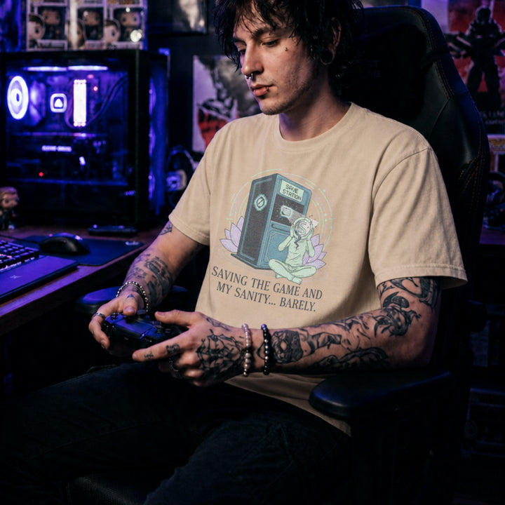 Translation missing: en.Natural tee with a meditating figure holding a cracked head by a Save Station. Text: Saving the game and my sanity