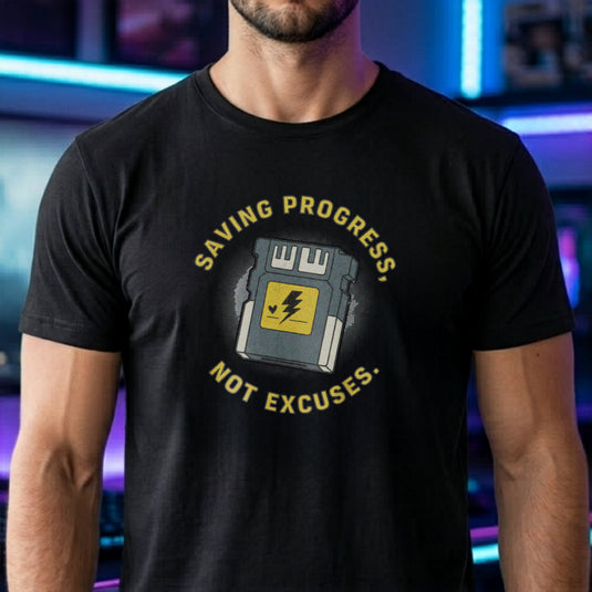 Translation missing: en.Black t-shirt with yellow text reading Saving Progress, Not Excuses around a retro console memory card icon